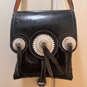 Unique Black Leather Women's Bag with Decorative Accents.